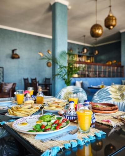 a table with plates of food and drinks on it at Dar Jasmine in Chefchaouene