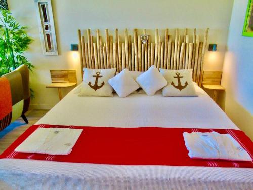 a bedroom with a large white bed with pillows at studio :paradise beach in Anse Marcel 