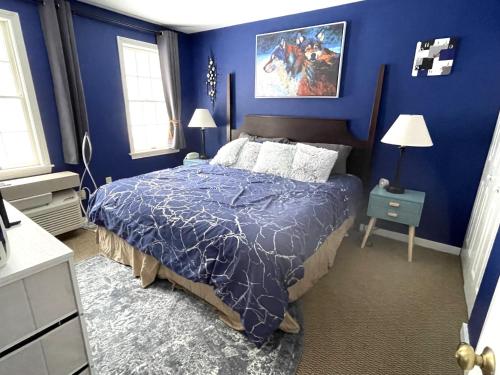 a blue bedroom with a bed with a blue wall at Mountain View Suite on Jiminy Peak Ski On Off -New in Hancock