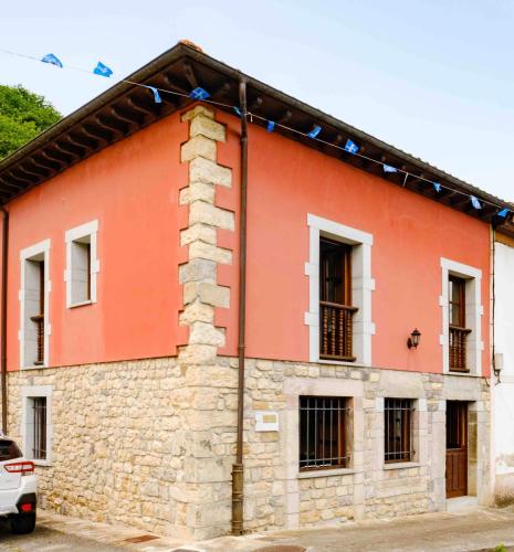 a red brick building with windows at La Bolera - Casa Pandal in Llanes