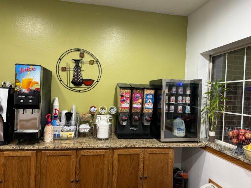 a kitchen with a counter with two refrigerators on it at Forest City Inn in Forest City