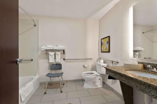 a bathroom with a toilet and a sink and a shower at Comfort Suites in Bastrop