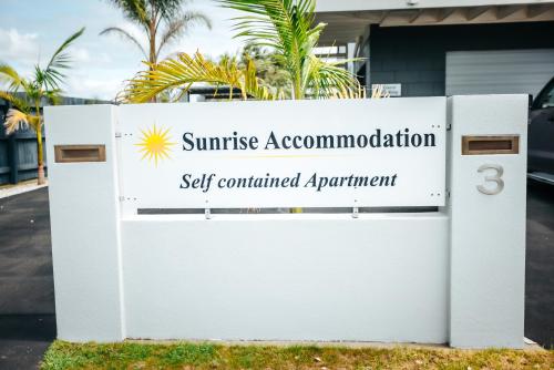 a sign for the sun service accommodation set contained appointment at Sunrise Accommodation in Whakatane