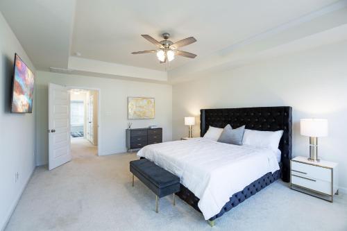 a bedroom with a large bed and a ceiling fan at Modern Oasis in Beulah Village