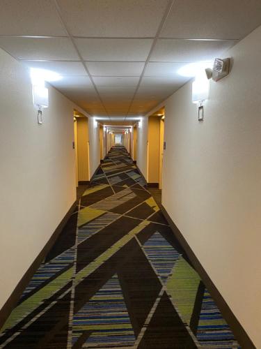 an empty hallway with a colorful floor in a building at Holiday Inn Express Metropolis by IHG in Metropolis