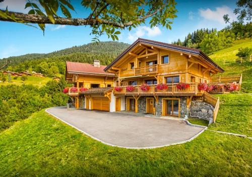 a large wooden house with a large driveway at Chalet Caramel - Les Congères in Manigod
