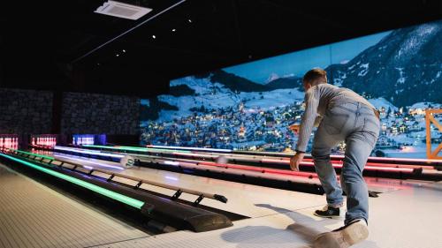 a man riding a skateboard down a bowling alley at Unique Penthouse Near City Center And Park in Roosendaal
