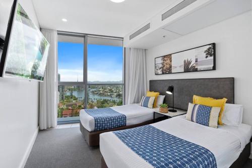 a hotel room with two beds and a large window at Spectacular Views from Wyndham Apartment in Gold Coast