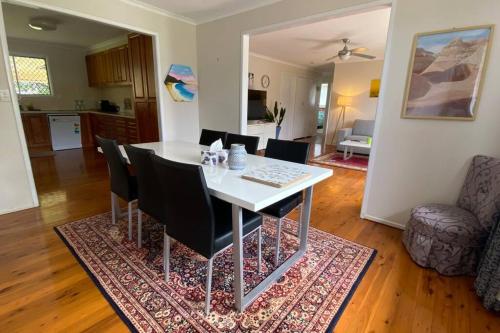 a dining room and living room with a table and chairs at Spacious 4-Bedroom house in a shared property in Harristown