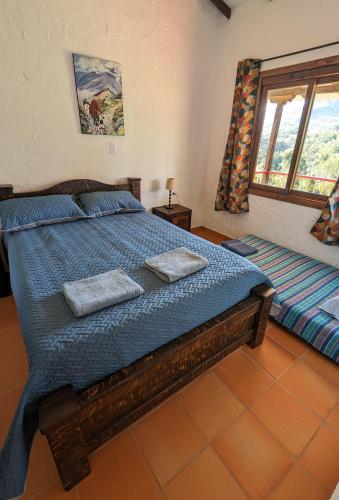 a bedroom with a bed with two pillows on it at Cabañas Nazak Lago 1 in Pereira