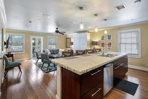 a kitchen with a counter top and a living room at Cloud Suite On Duval in Key West