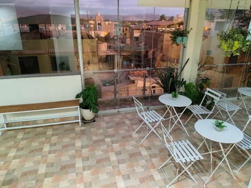 a patio with tables and chairs and a view of the city at Hotel Kallma Adventures in Ica