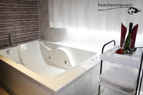 
a white bath tub sitting next to a white toilet at Torrejoven in Torrevieja
