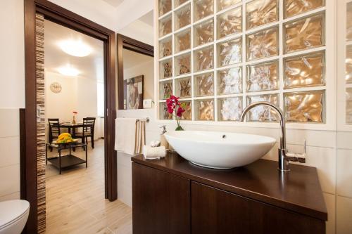 a bathroom with a sink and a toilet at Apartments Villa Bianca in Rovinj
