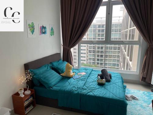 a bedroom with a blue bed with a large window at Creative Corner in Cyberjaya