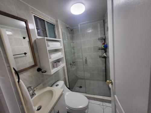 a bathroom with a shower and a toilet and a sink at Su Casa en Tijuana in Tijuana