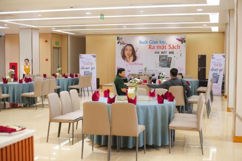 a group of people sitting at tables in a banquet hall at Phú Long Tam Kỳ Hotel & Restaurant in Tam Ky