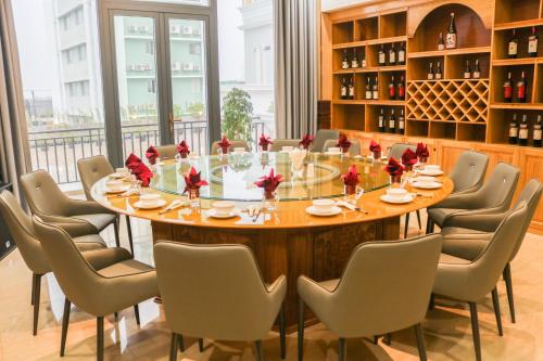 a large table in a room with chairs around it at Phú Long Tam Kỳ Hotel & Restaurant in Tam Ky
