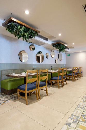 a dining room with a long table and chairs at Hotel Plaza Diana in Guadalajara