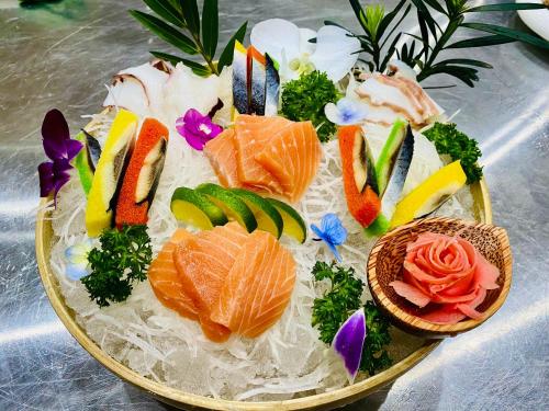 a plate of food with fish and vegetables on it at Phú Long Tam Kỳ Hotel & Restaurant in Tam Ky