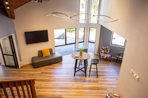 a large living room with a table and chairs at Haka House Queenstown Lakefront in Queenstown