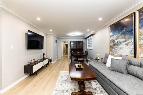 a living room with a couch and a table at Matilda’s Luxury House in Mississauga