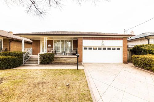 a brick house with a white garage door at Matilda’s Luxury House in Mississauga