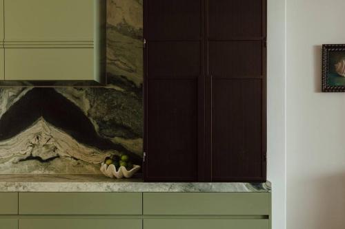 a bowl of fruit on a counter in a kitchen at Tender is the Stay - Luxury designer 2BR Glenelg in Glenelg