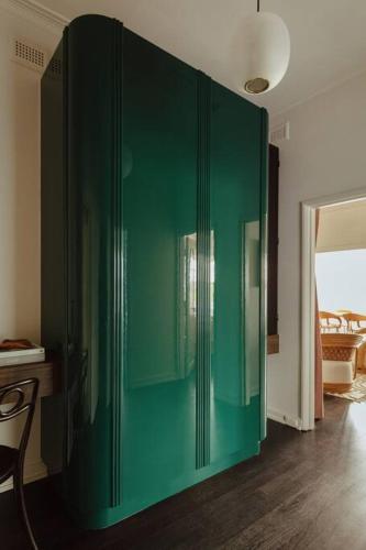 a green cabinet in the middle of a room at Tender is the Stay - Luxury designer 2BR Glenelg in Glenelg