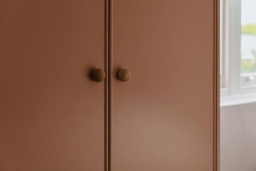 a door with two knobs on it next to a window at Tender is the Stay - Luxury designer 2BR Glenelg in Glenelg