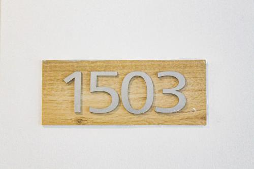 a wooden sign with the number on it at Titan Condo at Studio City Tower 3 Alabang in Manila