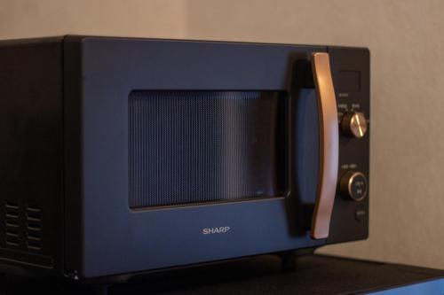 a blue microwave oven sitting on top of a table at Hotel Fu-Rin in Fukuoka