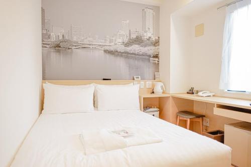 a bedroom with a bed with a view of a river at Travelodge Honmachi Osaka in Osaka