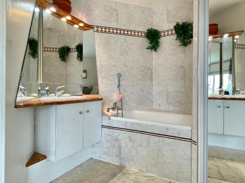 une salle de bain avec une baignoire, un lavabo et une douche dans l'établissement Spacieuse maison 6 pers à Sète - WIFI, animaux bienvenus, parking, clim mobile - FR-1-338-4, à Sète