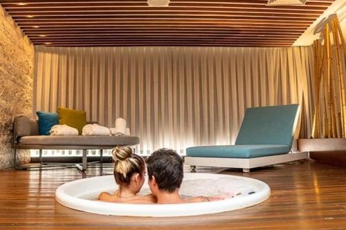 two people sitting in a bath tub in a room at Hotel Nacional Rio de Janeiro in Rio de Janeiro