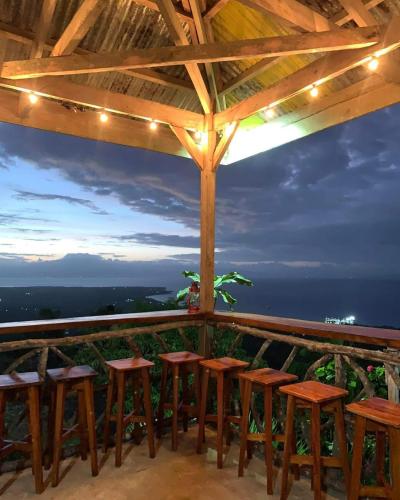 a bar with stools and a view of the ocean at Kamp Aninipot in Siquijor