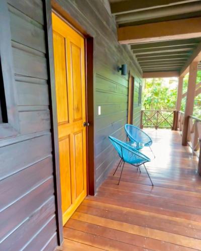 a blue chair sitting on the porch of a house at The Lodge at Punta Rica- Hilltop Eco-Lodge with Views & Pool in Bastimentos