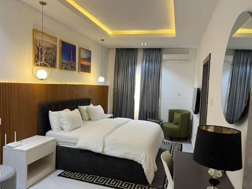 um quarto com uma cama, uma secretária e uma cadeira em Gorgeous 2 Bedroom with parking inside Banana Island, Ikoyi em Lagos