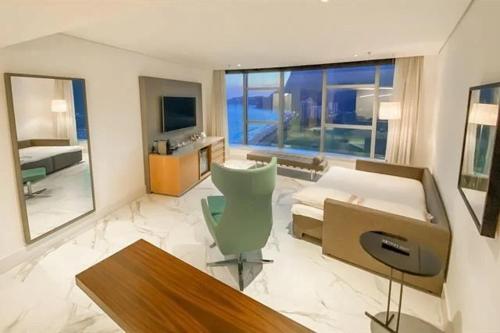 a large living room with a couch and a bed at Hotel Nacional Rio de Janeiro in Rio de Janeiro