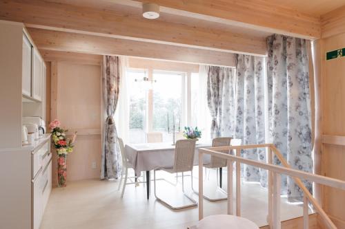 a dining room with a table and a window at Platina Luxe House in Toyama