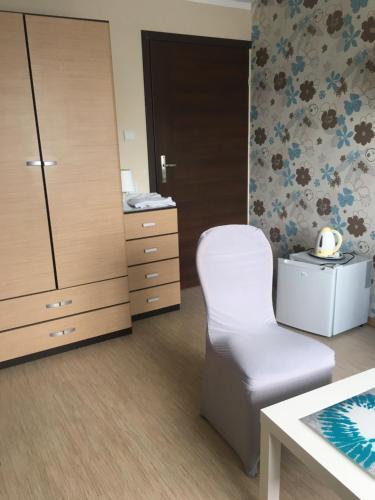a room with a chair and a dresser at PATIO dom gościnny in Łukęcin