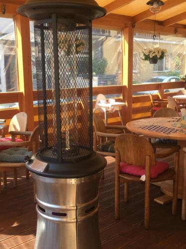 a grill in a restaurant with tables and chairs at PATIO dom gościnny in Łukęcin