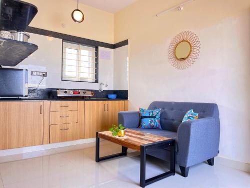 a living room with a couch and a table at ILYA SERVICED APARTMENTS in Bangalore