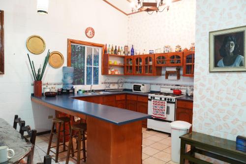 a kitchen with wooden cabinets and a counter top at El paraíso de Apaneca in Apaneca