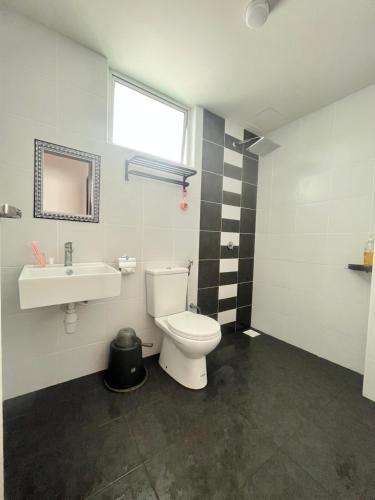 a bathroom with a toilet and a sink at Condominium Seri Alam, Masai #ANhome in Masai