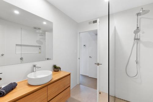 a bathroom with a sink and a shower at Dunsmore Lodge in Cowes