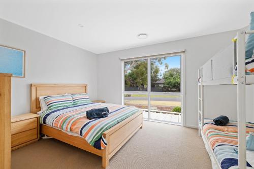a bedroom with two bunk beds and a window at Dunsmore Lodge in Cowes