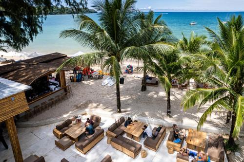 an overhead view of a beach with chairs and palm trees at Arinara Beach Resort Phuket - SHA Extra Plus in Bang Tao Beach