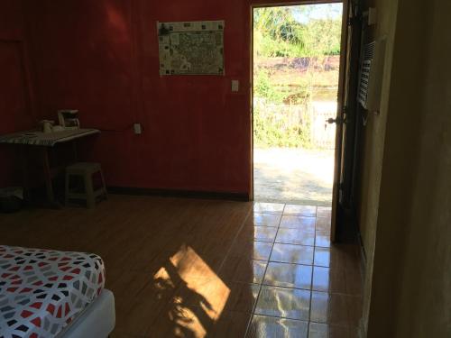 a bedroom with a bed and a door to a yard at AmyRooms in El Remate