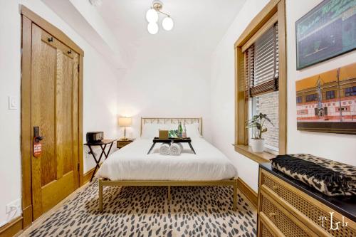 a bedroom with a bed and a window at The Twin Lions: Bespoke Travel Lodge w/ Speakeasy* in Chicago